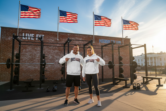 A man and a woman standing in front of a brick gym building with American flags and the White House in the background, wearing matching white hoodies with 'PATRIOT' printed across the front.