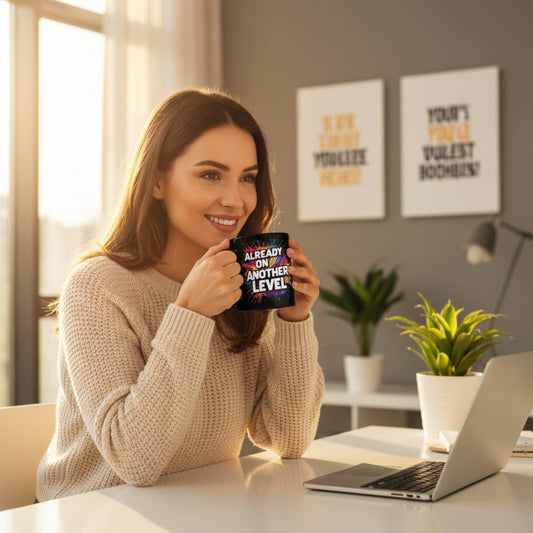 Black mug with colorful text 'ALREADY ON ANOTHER LEVEL' against a sunset sky.