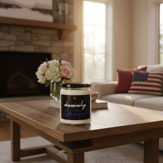 Candle jar with 'be obsessively Grateful' label next to an American flag on a wooden surface