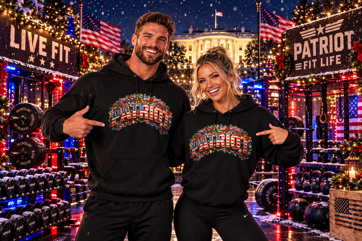 A man and a woman pose together in a festive, decorated gym environment at night, wearing matching black hoodies with a colorful Christmas 'PATRIOT' graphic across the chest.