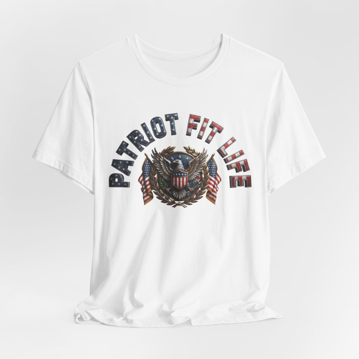 A white short-sleeve crewneck t-shirt featuring a patriotic graphic on the chest with the text 'PATRIOT FIT LIFE' and an eagle emblem with American flag details, shown against a light gray background.