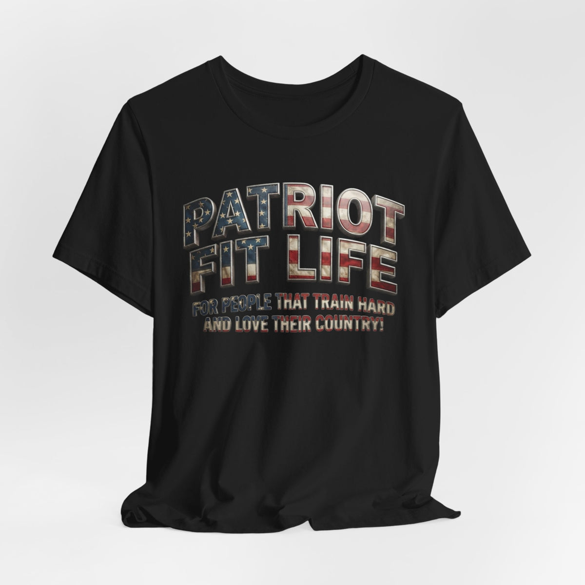 A black short-sleeve t-shirt with a distressed graphic on the chest reading 'PATRIOT FIT LIFE' in an American flag pattern and the slogan 'FOR PEOPLE THAT TRAIN HARD AND LOVE THEIR COUNTRY!' underneath, shown on a light gray background.