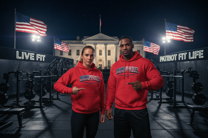 Two people standing in an outdoor gym at night wearing matching red hoodies with 'UNSTOPPABLE' printed on the chest, with the White House, American flags, and lit PATRIOT FIT LIFE and LIVE FIT signage in the background.
