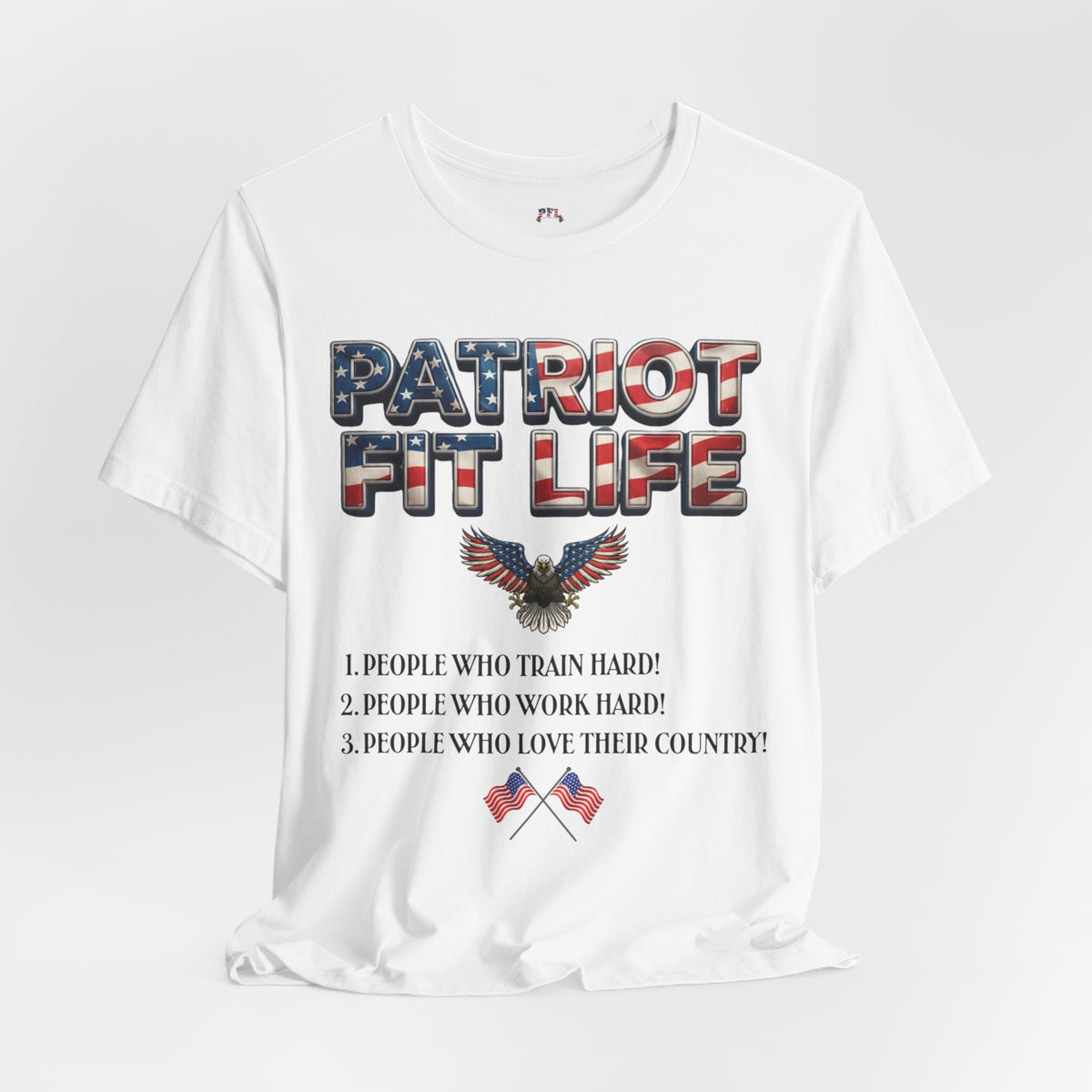 A white short-sleeve crewneck t-shirt with a patriotic graphic on the front. The graphic features the text 'PATRIOT FIT LIFE' in a distressed American flag pattern, an eagle illustration, and three motivational phrases ending in 'COUNTRY!'.