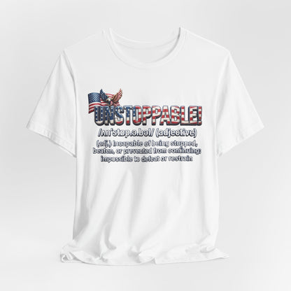 A white short-sleeve crewneck t-shirt with a graphic print on the front. The graphic features the word 'UNSTOPPABLE!' in a distressed red, white, and blue font, accompanied by a small American flag and eagle illustration, followed by a dictionary definition of the word 'unstoppable' in black text.