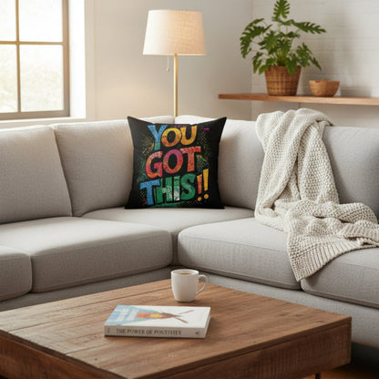 Living room with a gray sofa, wooden coffee table, and decorative pillow.