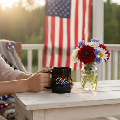 Person holding a mug with 'Blessed' text on a porch with an American flag in the background.