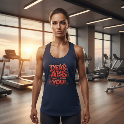 A female wearing a navy tank top with red text that says, Dear Abs I Will Find You! in a gym setting
