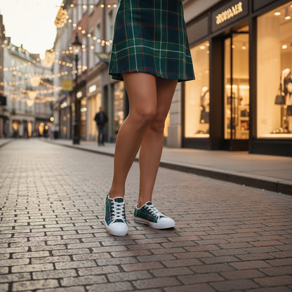 Person wearing green plaid skirt and matching sneakers on a city street.
