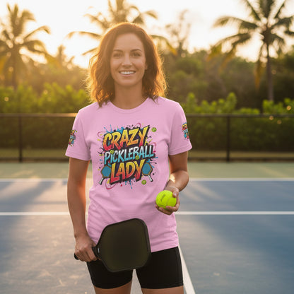 A woman wearing a pink t-shirt with a 'Crazy Pickleball Lady' design on a pickleball court.