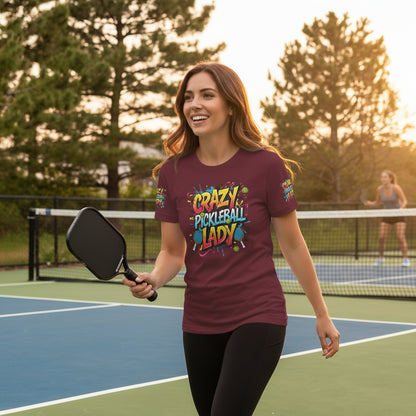 Maroon t-shirt with colorful 'Crazy Pickleball Lady' text and graphics on a pickleball court background.