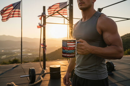 A man holding a mug that says Stronger Than Yesterday with an American flag design, standing on a deck with fitness equipment and American flags in the background.
