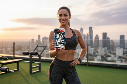 Woman in athletic wear showing an Untamed phone case with a city skyline in the background.