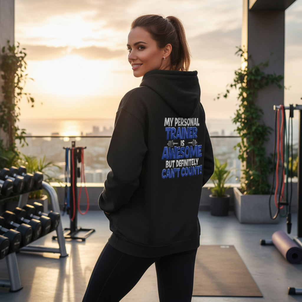 Woman wearing a black hoodie with text in an outdoor gym setting
