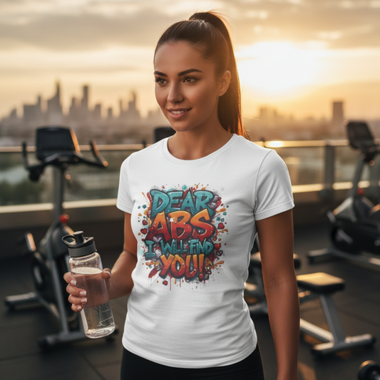 Woman in a gym wearing a t-shirt with 'Dear Abs, I will find you!' text.