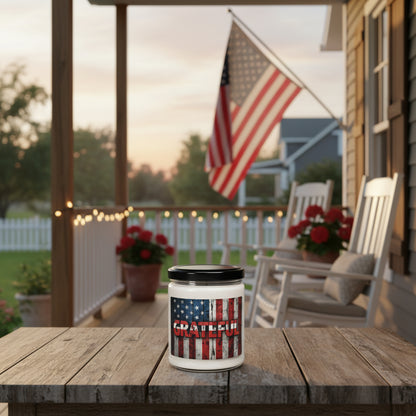 Candle jar with American flag design and 'GRATEFUL' text next to an American flag on a wooden surface.