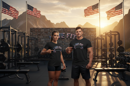 A male and female wearing matching black graphic t-shirts that read 'LIVE FIT' in front of a mountain gym backdrop with American flags at sunset.
