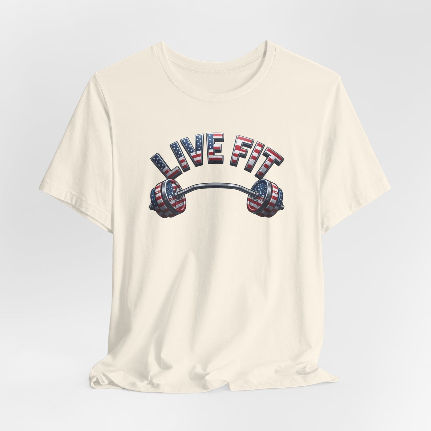 An off-white crewneck t-shirt featuring a graphic of a barbell with an American flag pattern and the text 'LIVE FIT' in matching flag-styled letters.