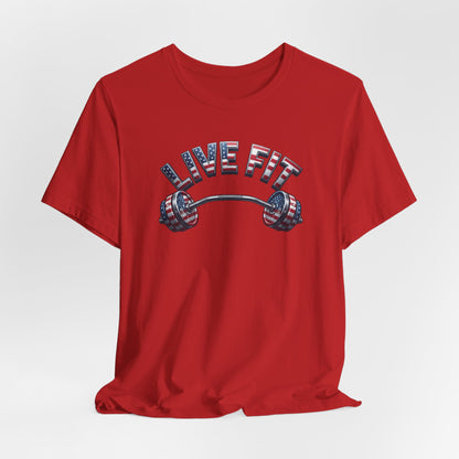 A red short-sleeve crewneck t-shirt featuring a graphic on the chest with the text 'LIVE FIT' in an American flag pattern above a barbell with matching flag stripes.