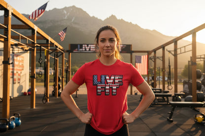 Woman wearing a 'LIVE FIT' shirt in an outdoor fitness area with mountains in the background.