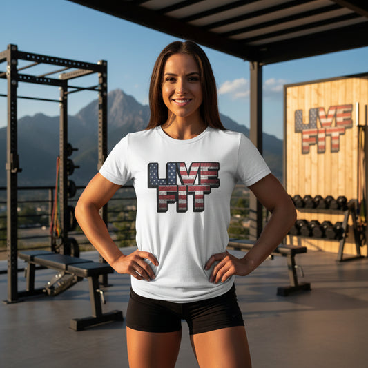 Woman wearing a 'Live Fit' t-shirt in a gym setting with mountains in the background.
