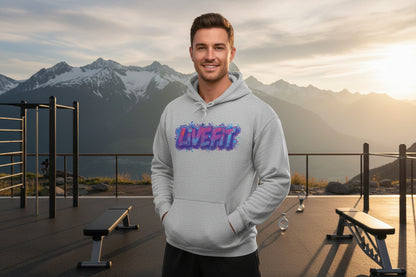 A man wearing a gray hoodie with a 'LiVE FiT' design in an outdoor setting with mountains.
