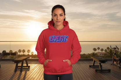 A woman wearing a red hoodie with 'LIVE FIT' text in a gym beach setting.