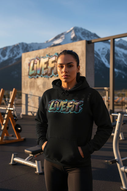 A woman wearing a black hoodie with the 'LIVE Fit' logo in an outdoor setting with mountains.