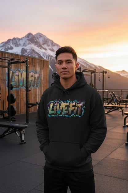 Person wearing a black hoodie with 'LIVE FIT' text in a colorful font inside a gym.