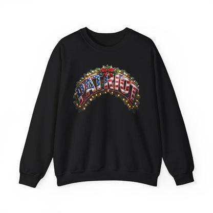 A black patriotic Christmas crewneck sweatshirt featuring a large graphic on the chest that reads 'PATRIOT' in an arched, American flag-themed design with red, white, and blue colors and green pine branches.