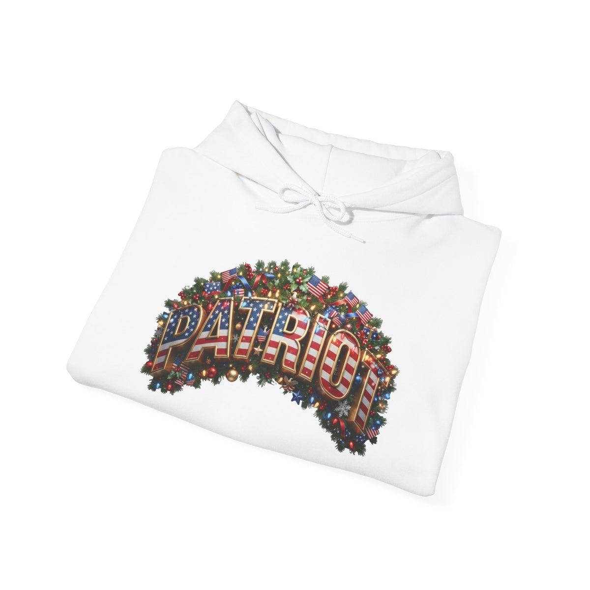 A folded white hoodie on a clean white background, featuring a large patriotic Christmas graphic on the chest with the word 'PATRIOT' filled with an American flag pattern and surrounded by a green wreath design.