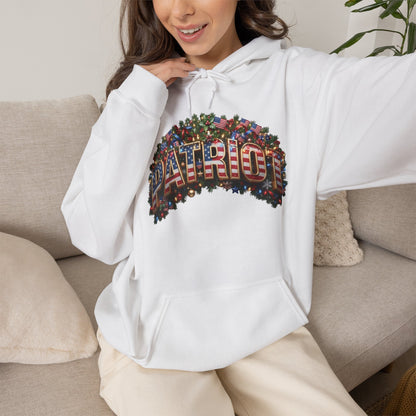A woman wearing a white hoodie with a patriotic Christmas design sitting on a couch.