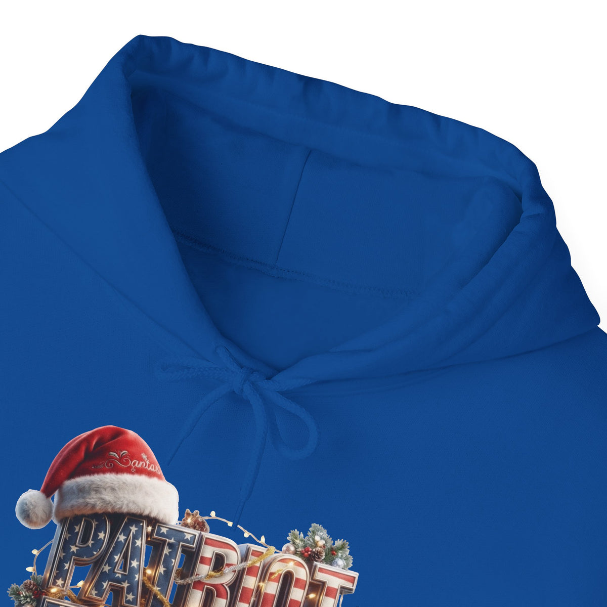 A close-up of a royal blue hoodie with a drawstring hood, featuring a festive graphic at the bottom left that reads 'PATRIOT' in metallic letters with a red Santa hat and holiday lights.