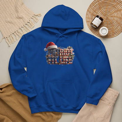 A royal blue pullover hoodie laid flat on a light beige surface, featuring a festive chest graphic that reads 'PATRIOT FIT LIFE' in red, white, and blue with a Santa hat.