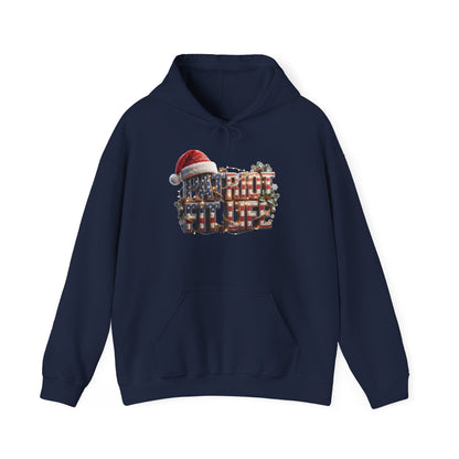 A navy blue pullover hoodie with a festive Christmas graphic on the chest. The graphic features the words PATRIOT FIT LIFE in stacked red, white, and blue text, topped with a red Santa hat, and decorated with green pine branches.