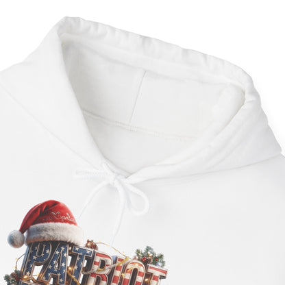 Close-up of a white pullover hoodie with a drawstring hood, featuring a festive graphic at the lower left that includes a red Santa hat and the word 'PATRIOT' over a flag-patterned background.