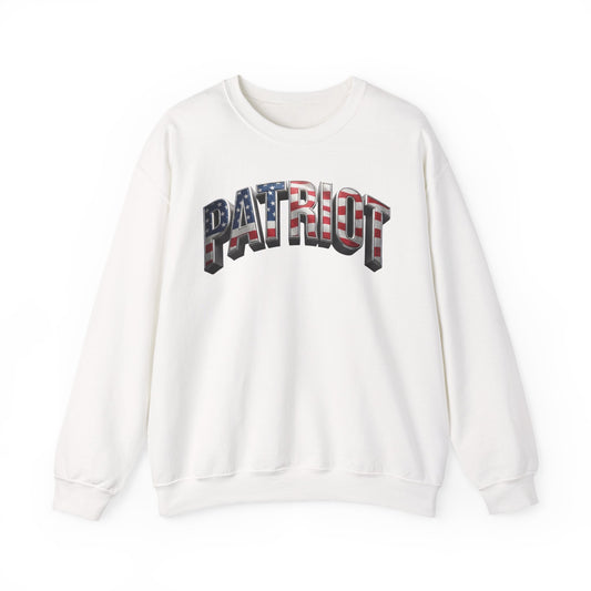 An off-white crewneck sweatshirt featuring the word 'PATRIOT' printed across the chest in a 3D block font filled with an American flag pattern of red, white, and blue stripes.