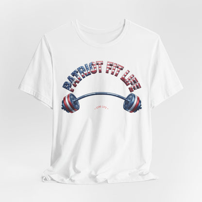 A white short-sleeve crewneck t-shirt featuring a patriotic graphic on the front with the text 'PATRIOT FIT LIFE' in an American flag pattern and a barbell illustration.