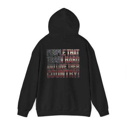 A black pullover hoodie shown from the back, featuring a graphic text print that reads 'PEOPLE THAT TRAIN HARD AND LOVE THEIR COUNTRY!' in a distressed red, white, and blue plaid pattern.