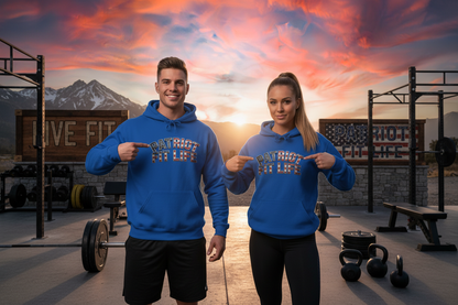 Two models wearing matching blue hoodies with a graphic that reads 'PATRIOT FIT LIFE' stand in front of a rustic outdoor gym at sunset with mountains in the background.
