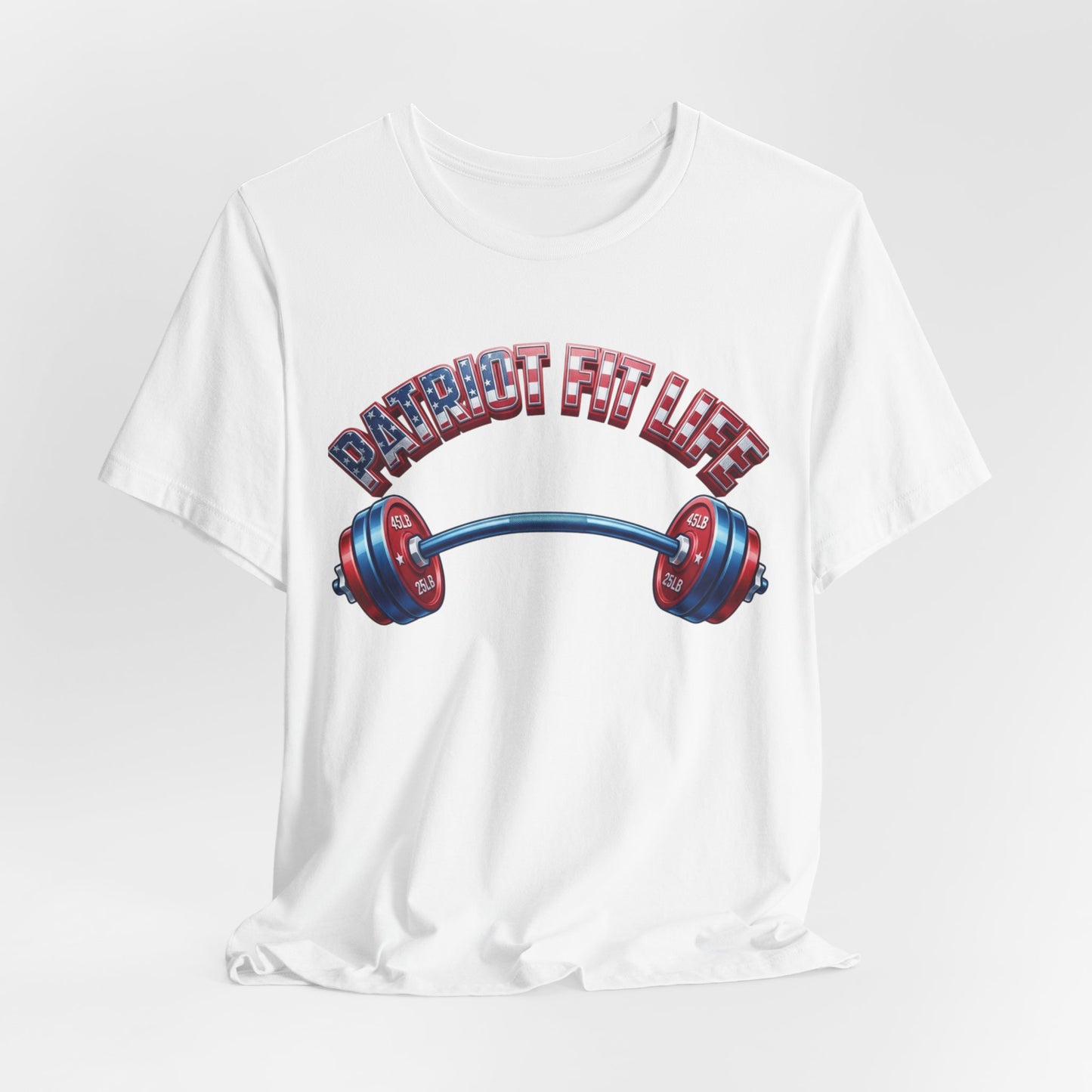 A white short-sleeve crewneck t-shirt featuring a graphic print of a barbell with red and blue weight plates and the text 'PATRIOT FIT LIFE' in an American flag pattern above it, set against a light gray background.