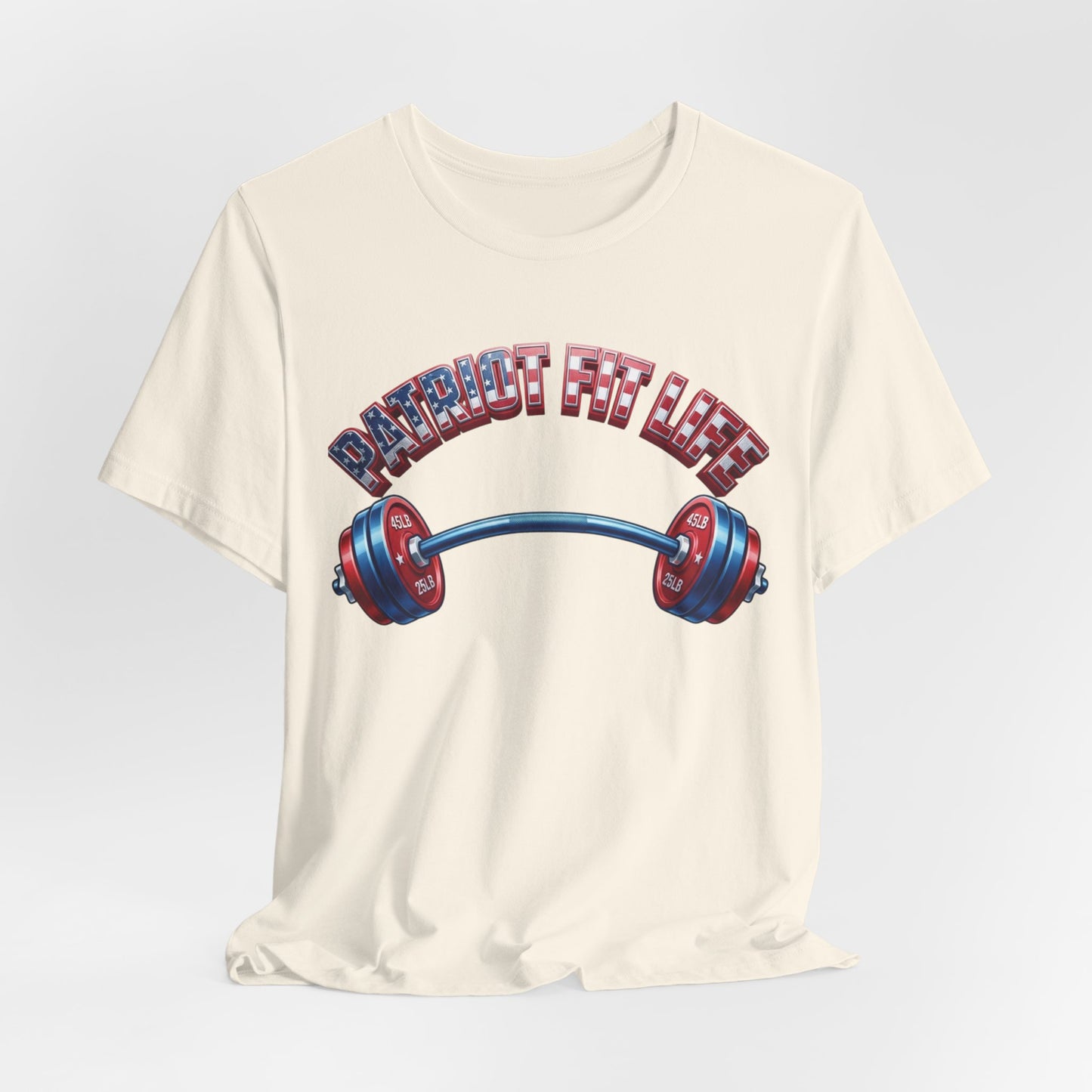 An off-white crewneck t-shirt featuring a graphic of a barbell with red and blue weight plates and the text 'PATRIOT FIT LIFE' in an American flag pattern, displayed on a light gray background.