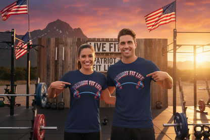 A man and a woman standing on a rustic outdoor fitness platform at sunset, wearing matching navy blue t-shirts with a patriotic red, white, and blue graphic that reads 'Patriot Fit Life'.