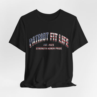 A black short-sleeve crewneck t-shirt with a patriotic graphic on the chest reading 'PATRIOT FIT LIFE' in an American flag pattern, with 'EST. 2023' and 'STRENGTH HONOR PRIDE' below, shown on a light gray gradient background.