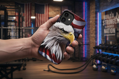 Phone case with eagle and American flag design held by a hand in a gym setting.