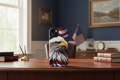 Phone case with an American flag eagle design on a desk with books and decor.