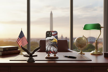Phone case with American flag and bald eagle design on a desk with American flag, globe, and lamp.