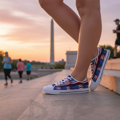 A woman wearing sneakers with an American flag design at sunset with monuments in the background.