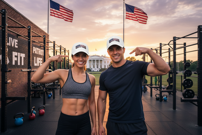 A smiling woman and man pose together in a gym at sunset, both wearing matching white baseball caps with the 'UNSTOPPABLE!' logo. The background features a brick wall, weight racks, kettlebells, and the White House in the distance under American flags.