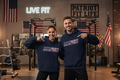 A man and a woman are standing in an inside gym, both wearing matching navy blue hoodies with a patriotic red, white, and blue UNSTOPPABLE! graphic on the chest. The background features American flags, weight racks, and a neon sign that reads 'LIVE FIT.'